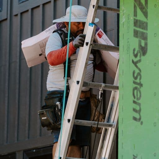 ARRT worker climbing ladder on job site