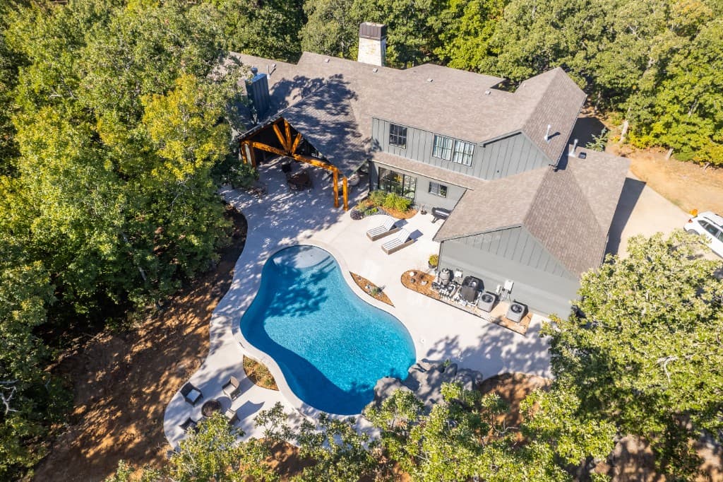 Aerial view of home with pool roofed by ARRT