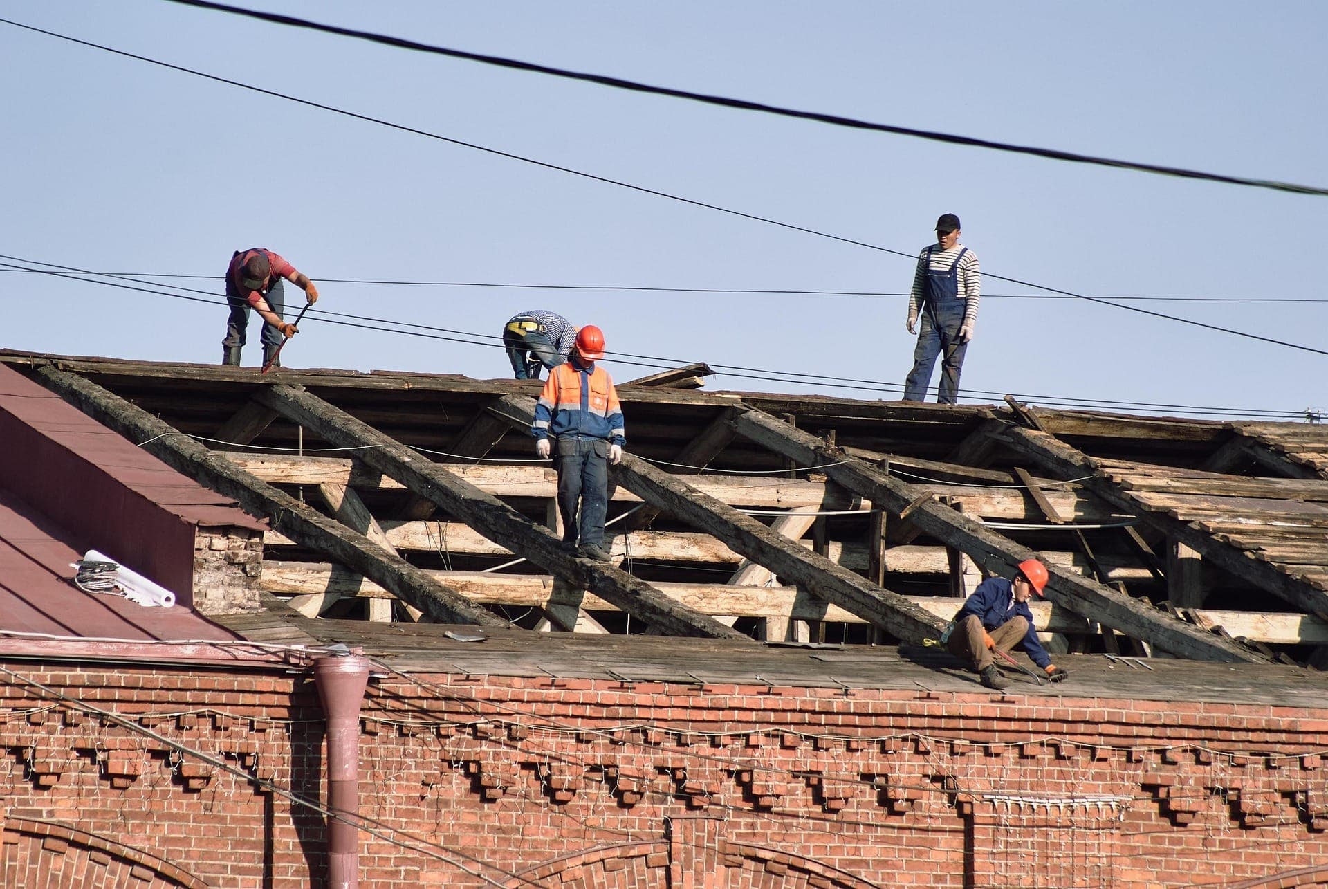 Roofing crew working on structural roof repairs